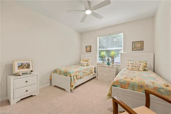 a bedroom with two beds and window