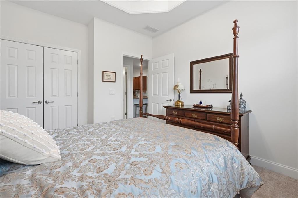 3328 Ivy Ridge Court Buford, GA 30519 - Photo 24 of 34 a bed room with a bed and a mirror