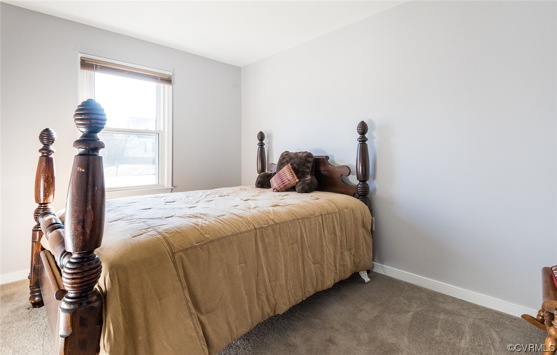 7807 Drexelbrook Road Chesterfield, VA 23832 - Photo 23 of 37 a bedroom with a bed and a chandelier