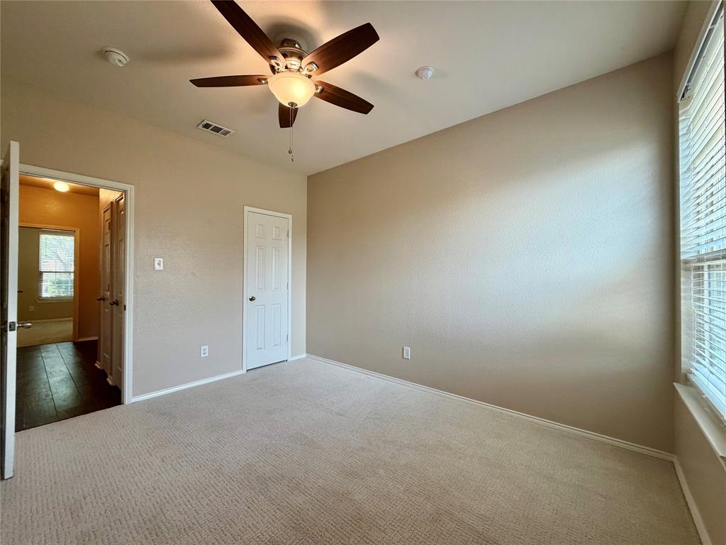 5817 Deck House Road Fort Worth, TX 76179 - Photo 11 of 19 Carpeted room with a ceiling fan, window with blinds, and white paneled doors