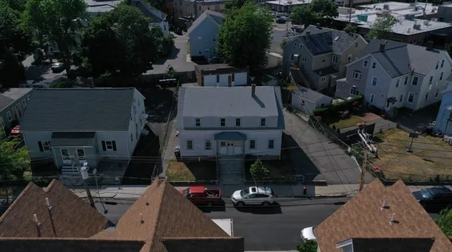 a view of a white house with a outdoor space