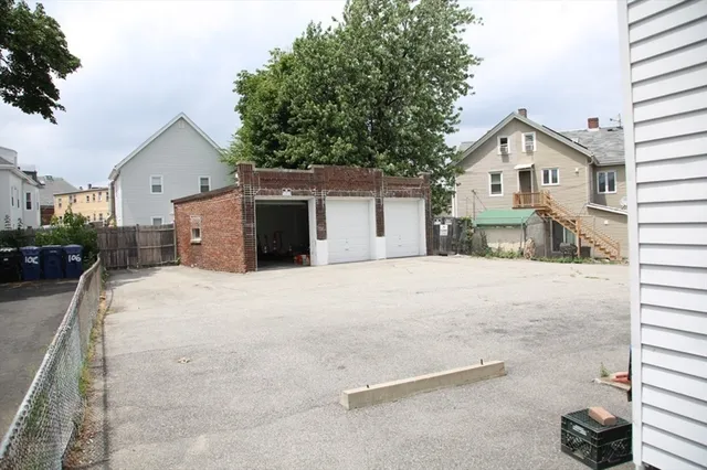 a white house that has a tree in front of it