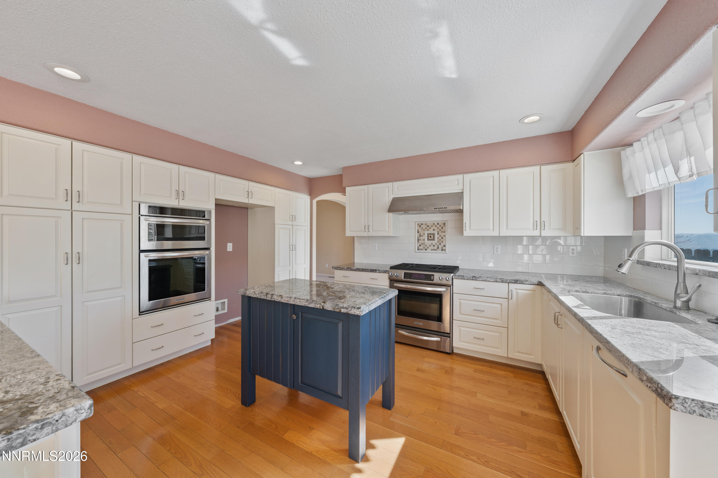 5524 Tappan Drive Reno, NV 89523 - Photo 17 of 70 a kitchen with stainless steel appliances granite countertop a stove a sink and a microwave