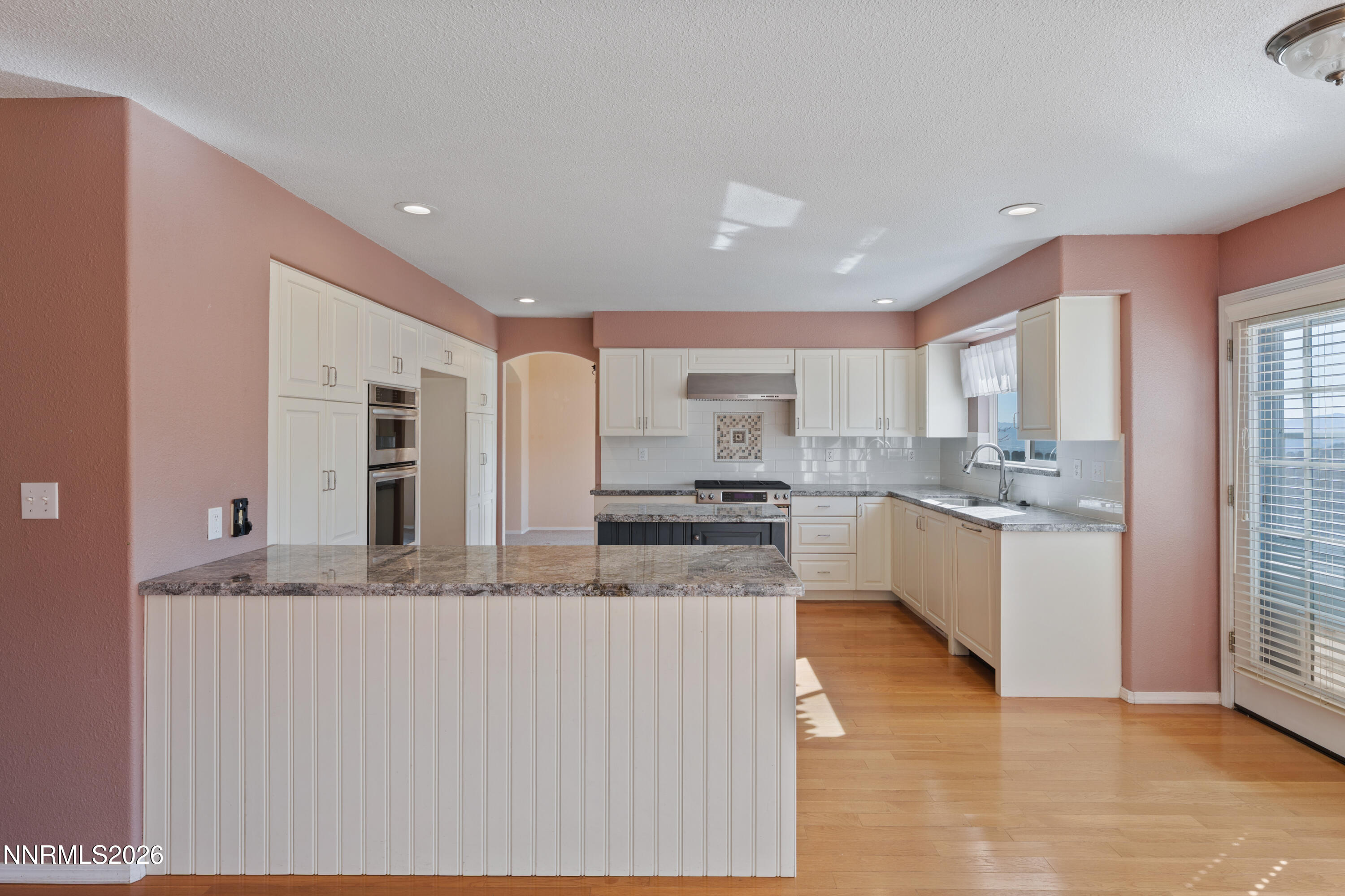 5524 Tappan Drive Reno, NV 89523 - Photo 19 of 70 a large kitchen with granite countertop a large counter top stainless steel appliances and windows