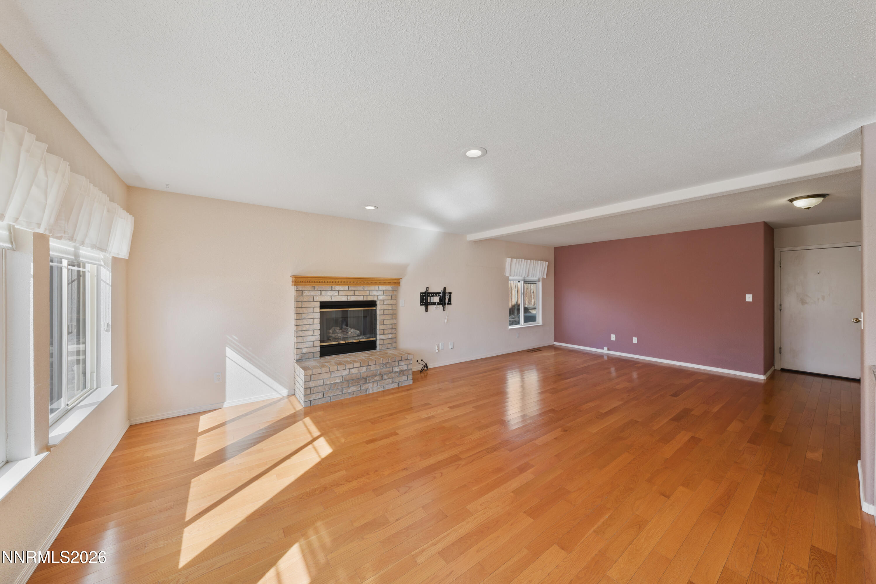 5524 Tappan Drive Reno, NV 89523 - Photo 21 of 70 a view of empty room with wooden floor and fireplace