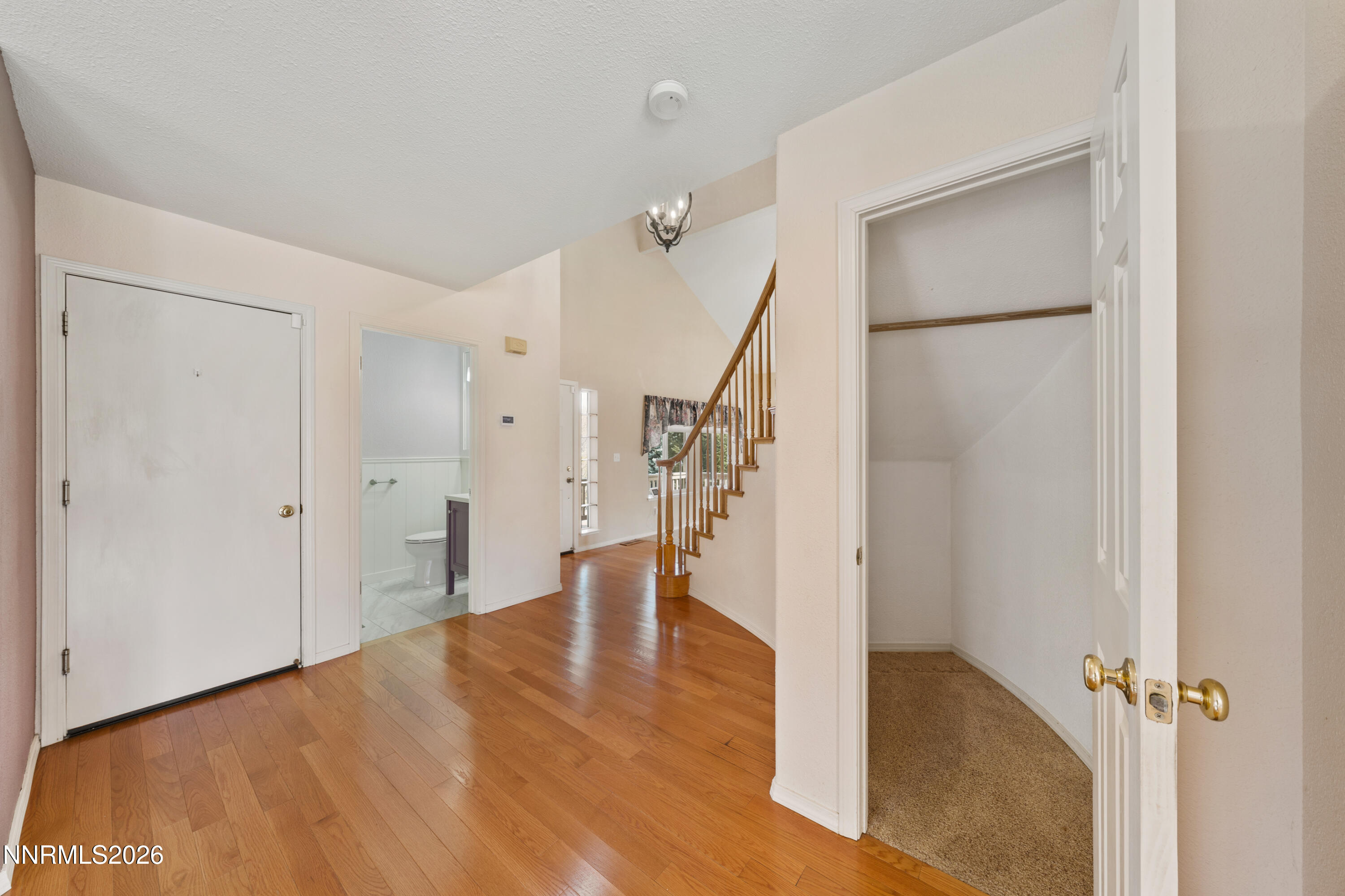 5524 Tappan Drive Reno, NV 89523 - Photo 5 of 70 a view of an empty room with wooden floor and a ceiling fan
