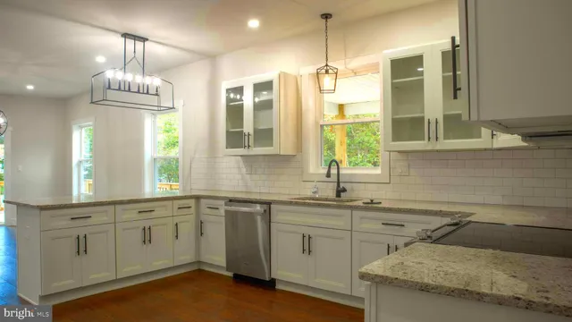 a kitchen with a sink stove and window