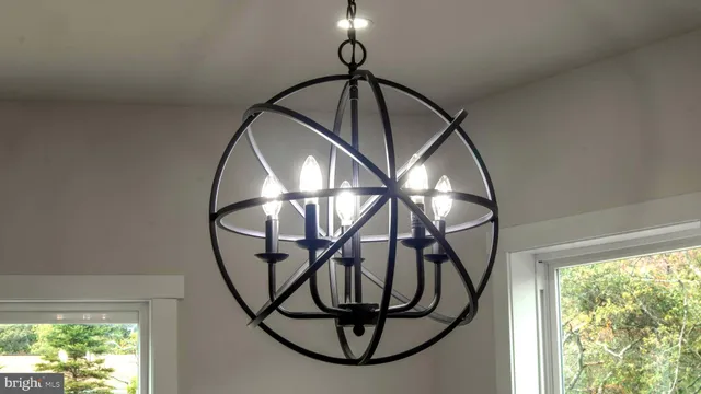 a view of staircase with kitchen view and a window