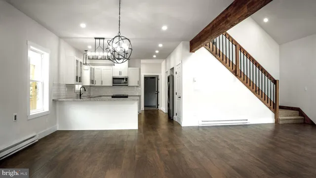 a view of an entryway with wooden floor