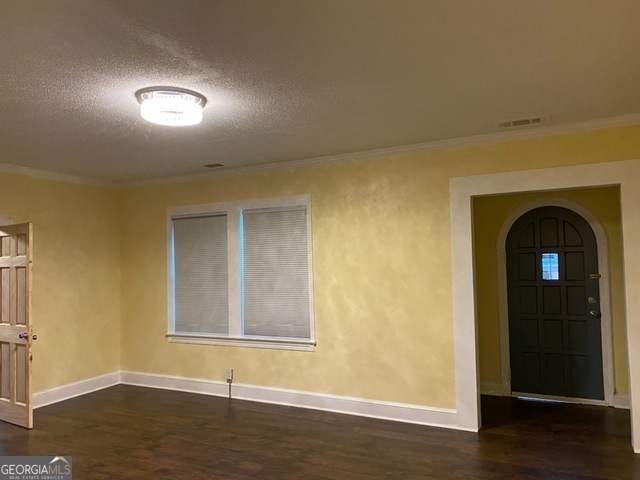 697 Grenada Terrace Macon, GA 31206 - Photo 3 of 18 a view of an empty room with wooden floor and a window