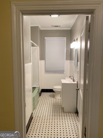 697 Grenada Terrace Macon, GA 31206 - Photo 8 of 18 a bathroom with a sink a toilet a mirror and vanity