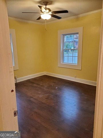 697 Grenada Terrace Macon, GA 31206 - Photo 10 of 18 an empty room with wooden floor fan and windows