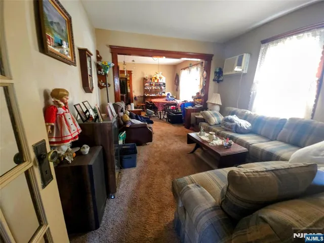a living room with furniture and a floor to ceiling window