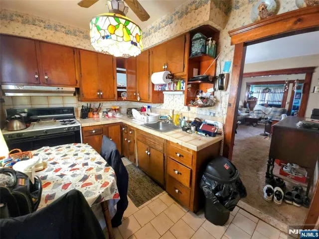 a kitchen with a sink stove and cabinets