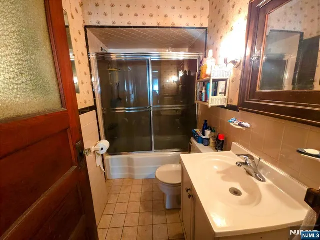 a bathroom with a sink and mirror with toilet