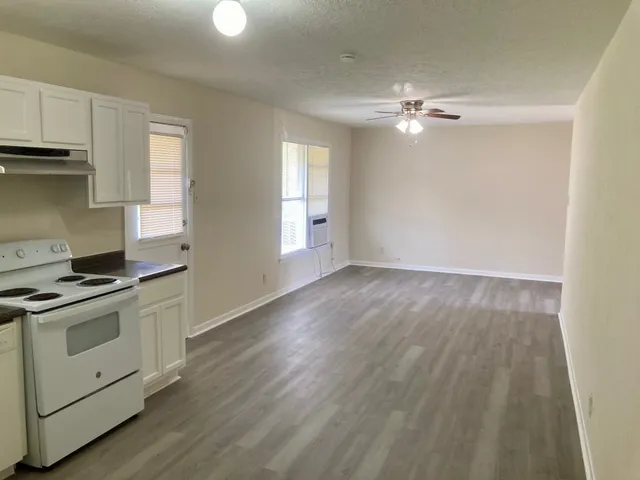 a view of a kitchen with a sink cabinets and wooden floor