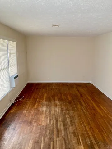 a view of a room with wooden floor and small space