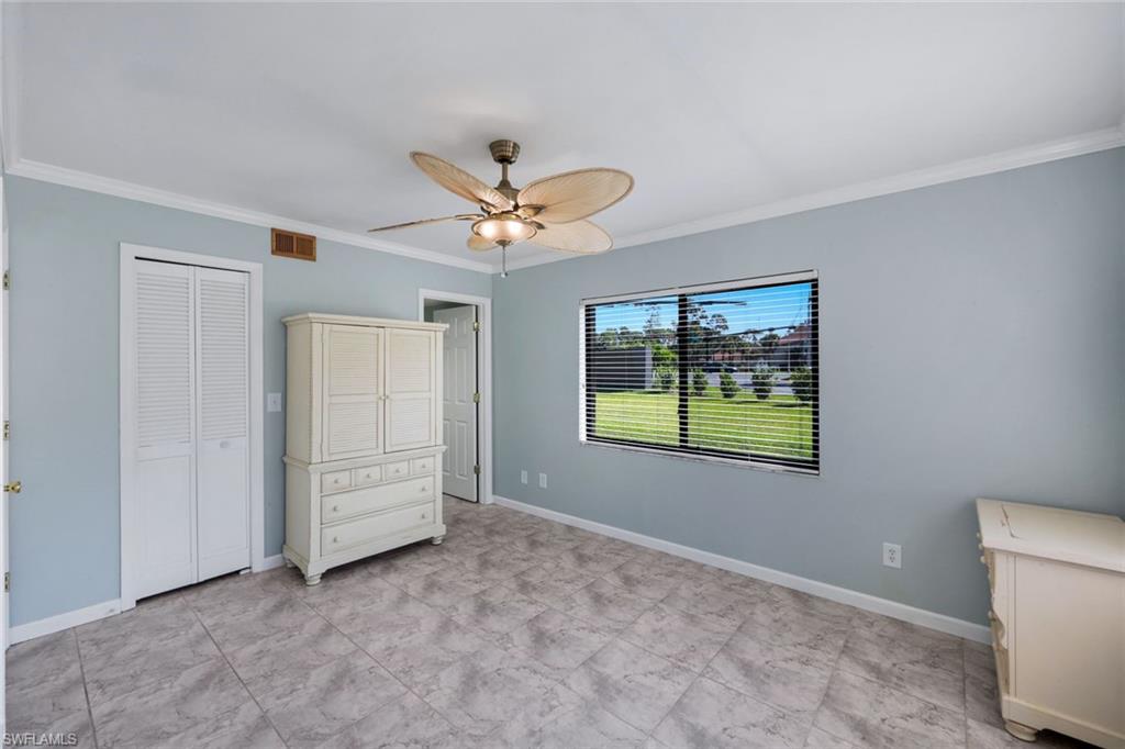 5857 Rattlesnake Hammock Road, Unit 101 Naples, FL 34113 - Photo 11 of 19 Room featuring tile flooring, white baseboards, and light blue walls