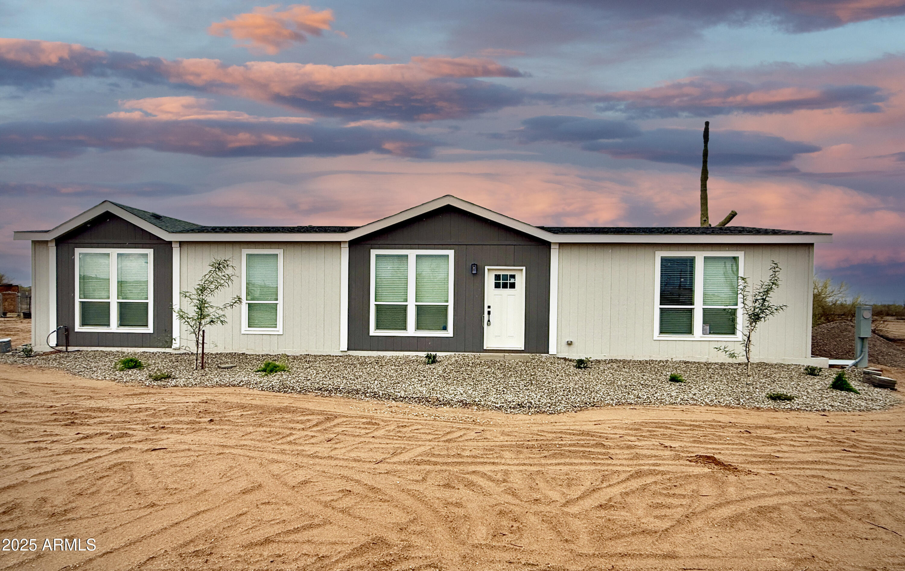 a front view of a house with a garden and pathway