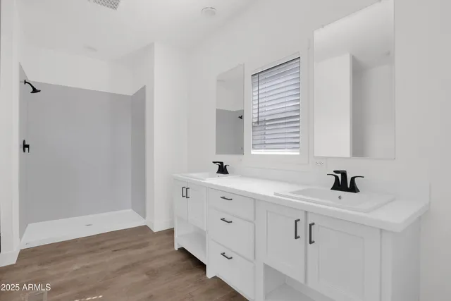 a bathroom with a sink a mirror and a window