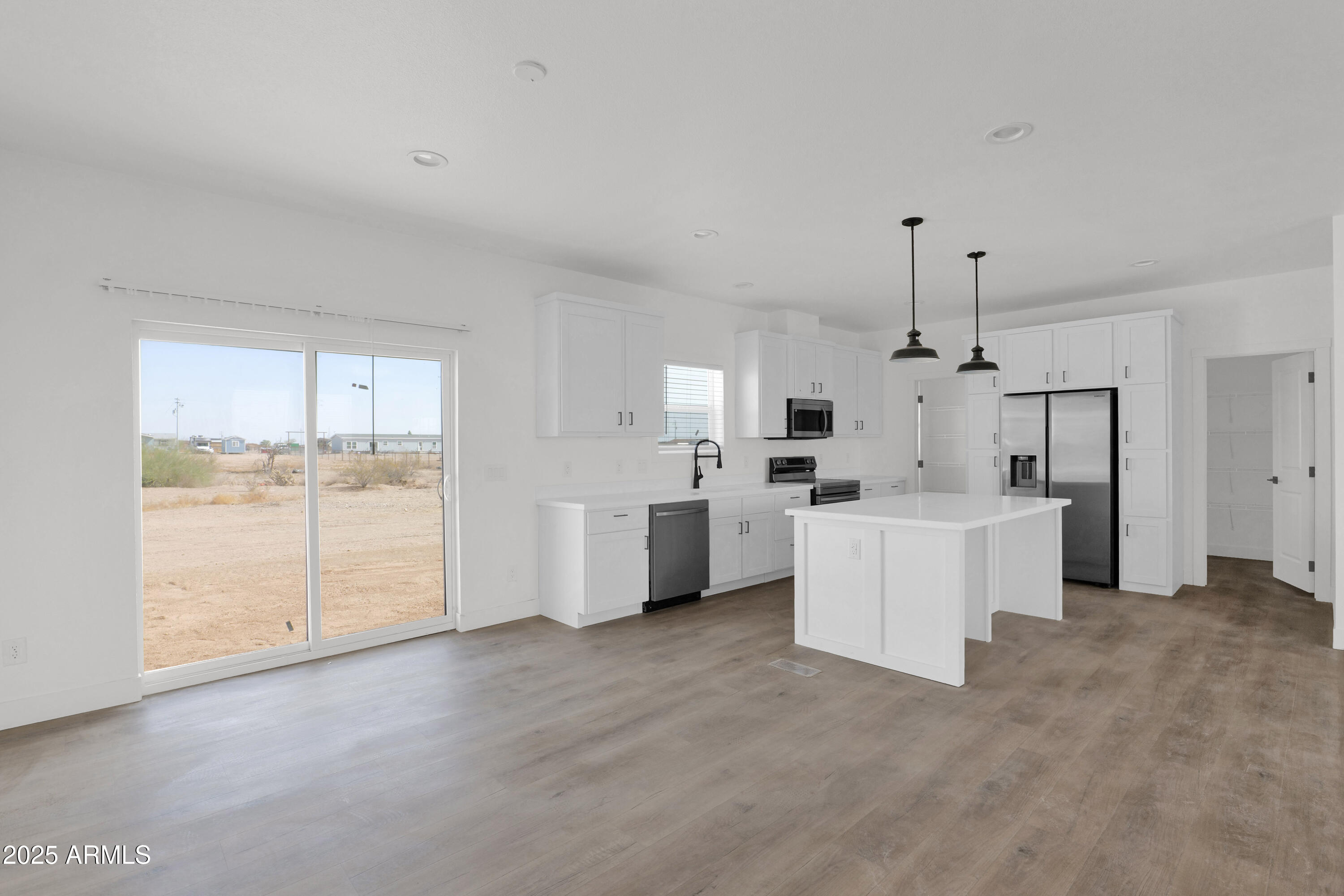 22367 North Royd Road Florence, AZ 85132 - Photo 4 of 22 a view of a kitchen with refrigerator and white cabinets