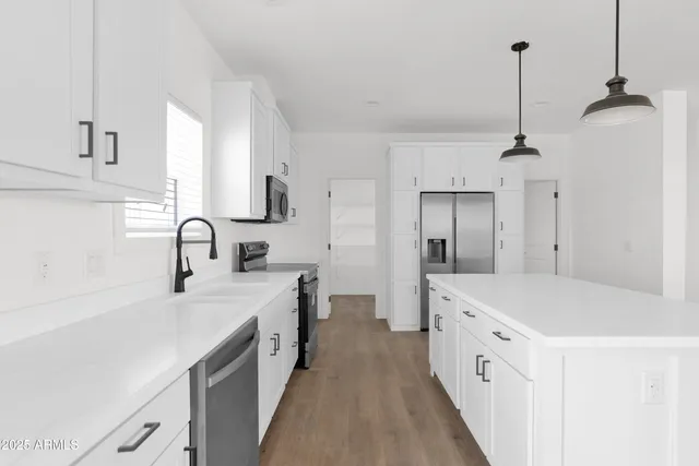 a kitchen with a sink stove and refrigerator
