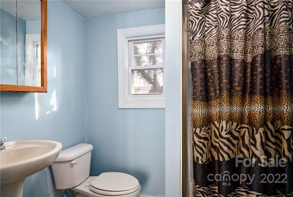 240 Duke Street Cooleemee, NC 27014 - Photo 11 of 18 a white toilet sitting next to a bathroom sink