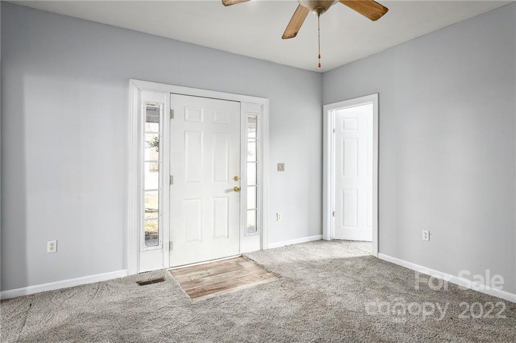 240 Duke Street Cooleemee, NC 27014 - Photo 4 of 18 a view of an empty room with a chandelier fan