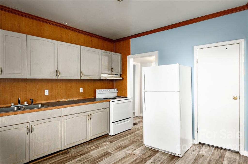 240 Duke Street Cooleemee, NC 27014 - Photo 7 of 18 a kitchen with cabinets and white appliances