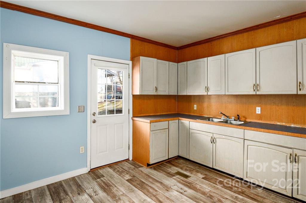 240 Duke Street Cooleemee, NC 27014 - Photo 8 of 18 a kitchen with granite countertop white cabinets and white appliances