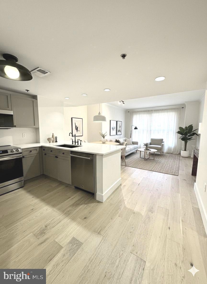 777 7th Street Northwest, Unit 322 Washington, DC 20001 - Photo 1 of 23 a large white kitchen with a sink and cabinets