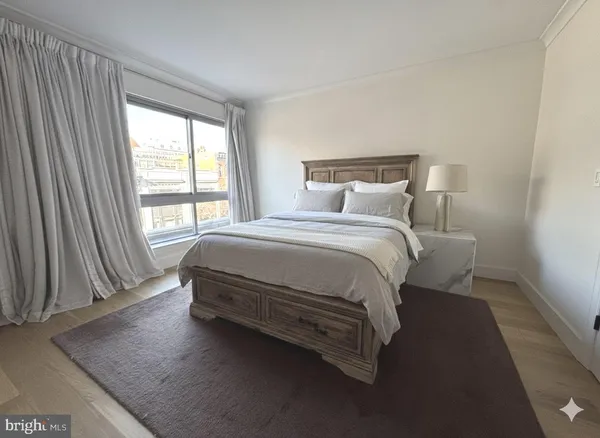 a bedroom with a bed lamp and window
