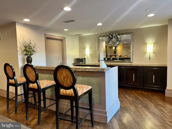 a kitchen with granite countertop a table chairs stove a sink and dishwasher