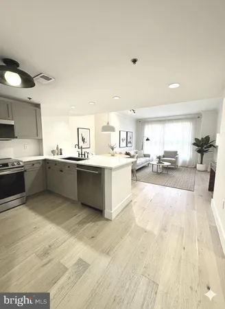 a large white kitchen with a sink and cabinets