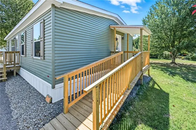 a view of a house with backyard and deck