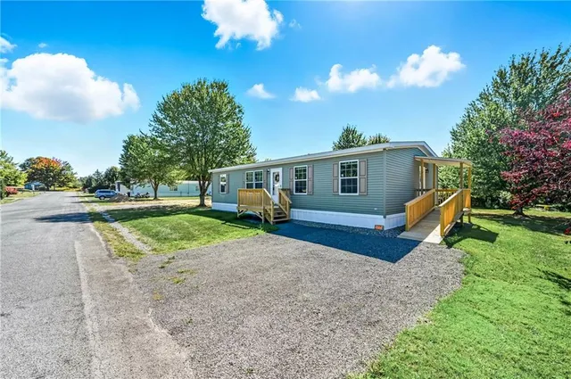 a view of a house with backyard and a garden