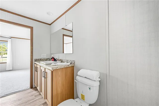 a bathroom with a toilet a sink and a window