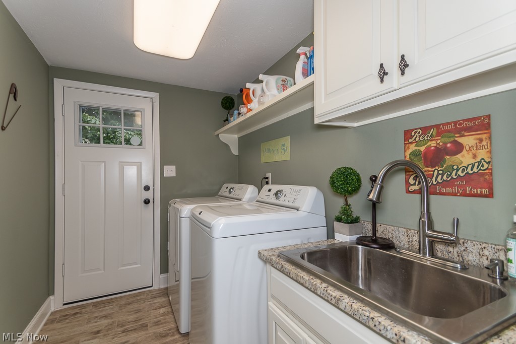 990 Roland Road Cleveland, OH 44124 - Photo 25 of 30 1st floor laundry with sink cabinet and lots of storage.
