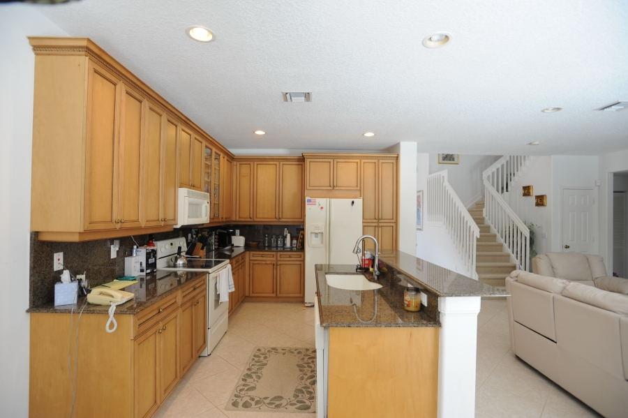 4804 South Classical Boulevard Delray Beach, FL 33445 - Photo 9 of 31 a kitchen with sink a stove and refrigerator