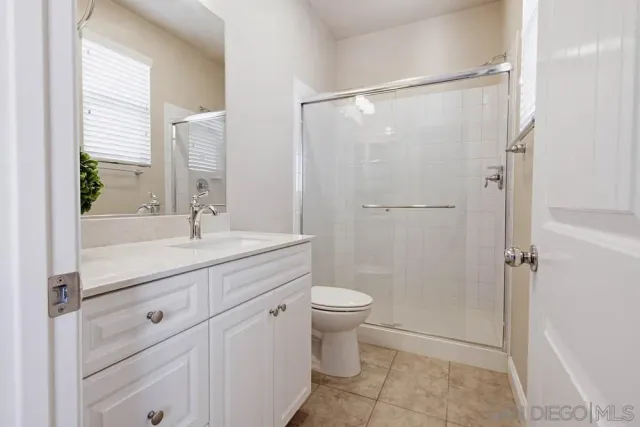 an empty room with wooden floor and closet