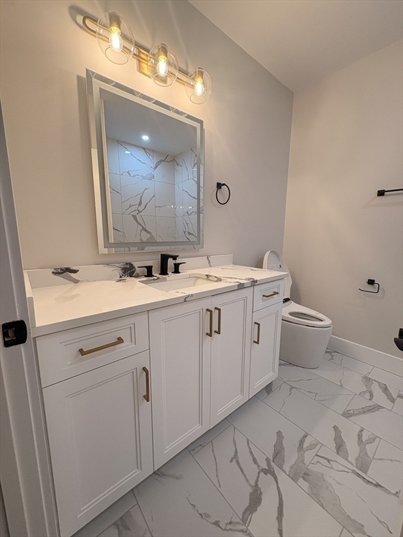 441 Washington Street, Unit 305 Dedham, MA 02026 - Photo 8 of 20 a bathroom with a double vanity sink and a mirror