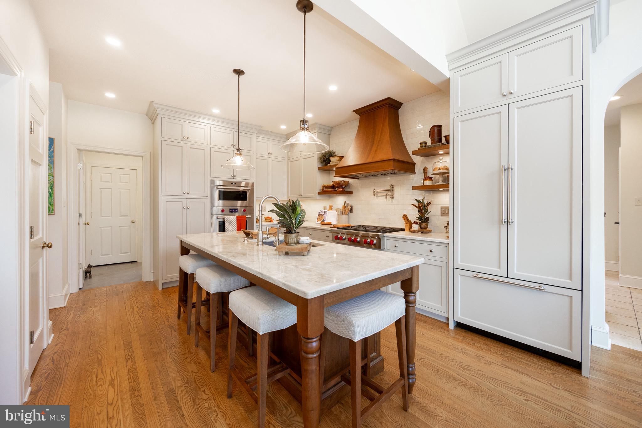 2220 Bodine Road Malvern, PA 19355 - Photo 22 of 86 a kitchen with stainless steel appliances granite countertop a sink a stove a refrigerator and island with wooden floor