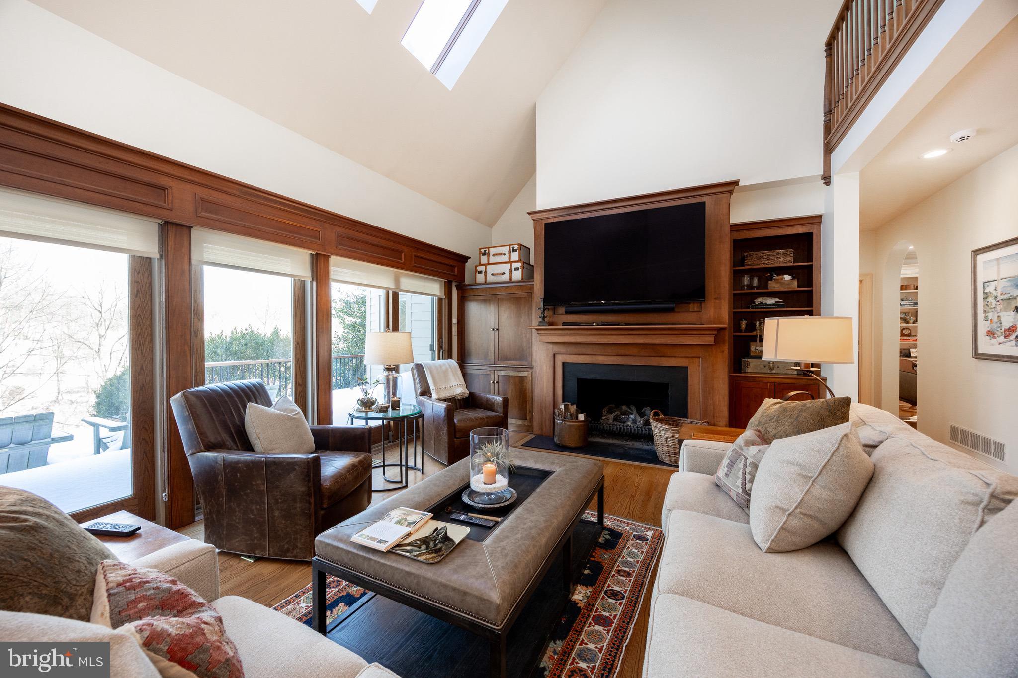 2220 Bodine Road Malvern, PA 19355 - Photo 30 of 86 a living room with furniture a flat screen tv and a fireplace