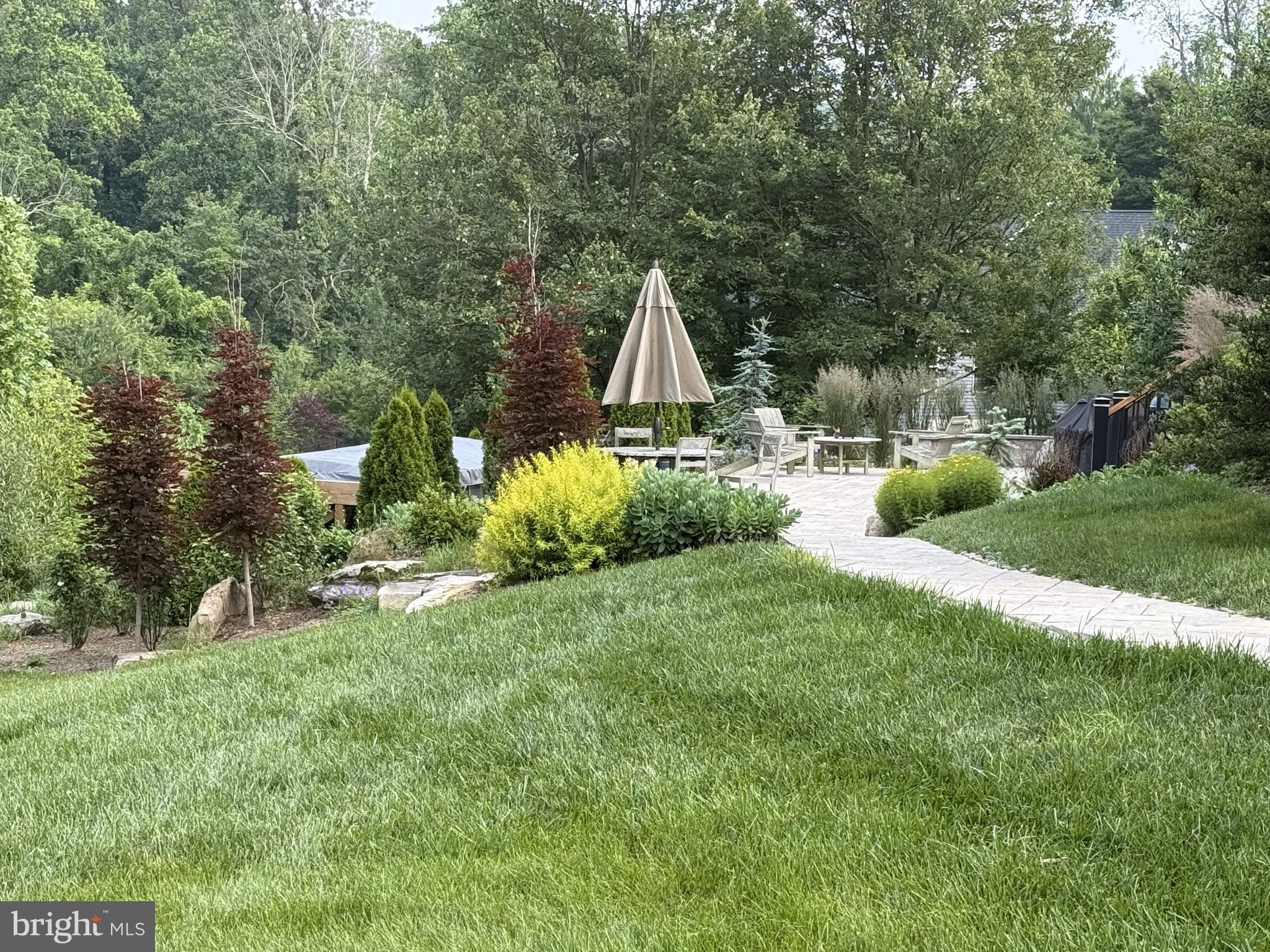 2220 Bodine Road Malvern, PA 19355 - Photo 8 of 86 a view of backyard with table and chairs and a large tree