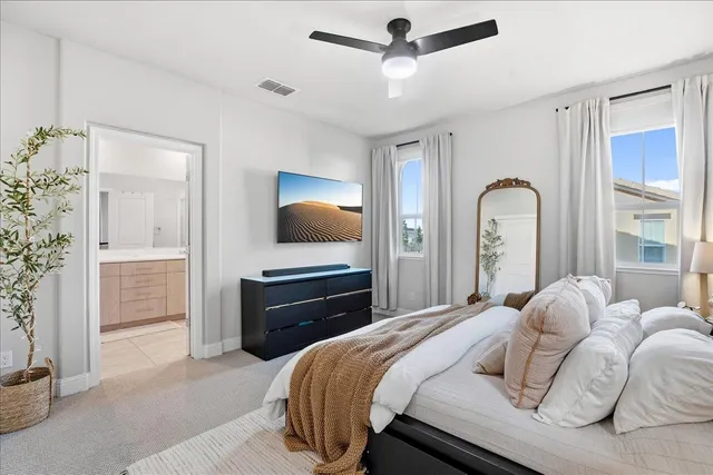 a bedroom with a bed and a flat tv screen