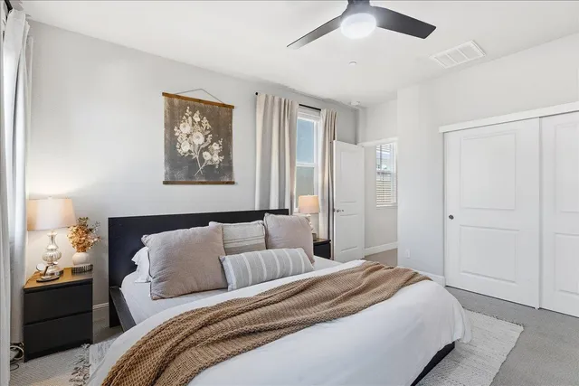 a bedroom with a bed and a painting on the wall