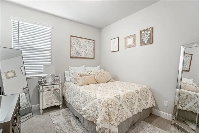 a bedroom with a bed and a flat tv screen
