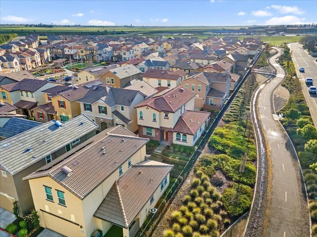 an aerial view of a residential houses with outdoor space