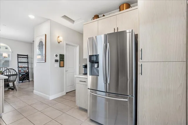 a metallic refrigerator freezer sitting in a kitchen