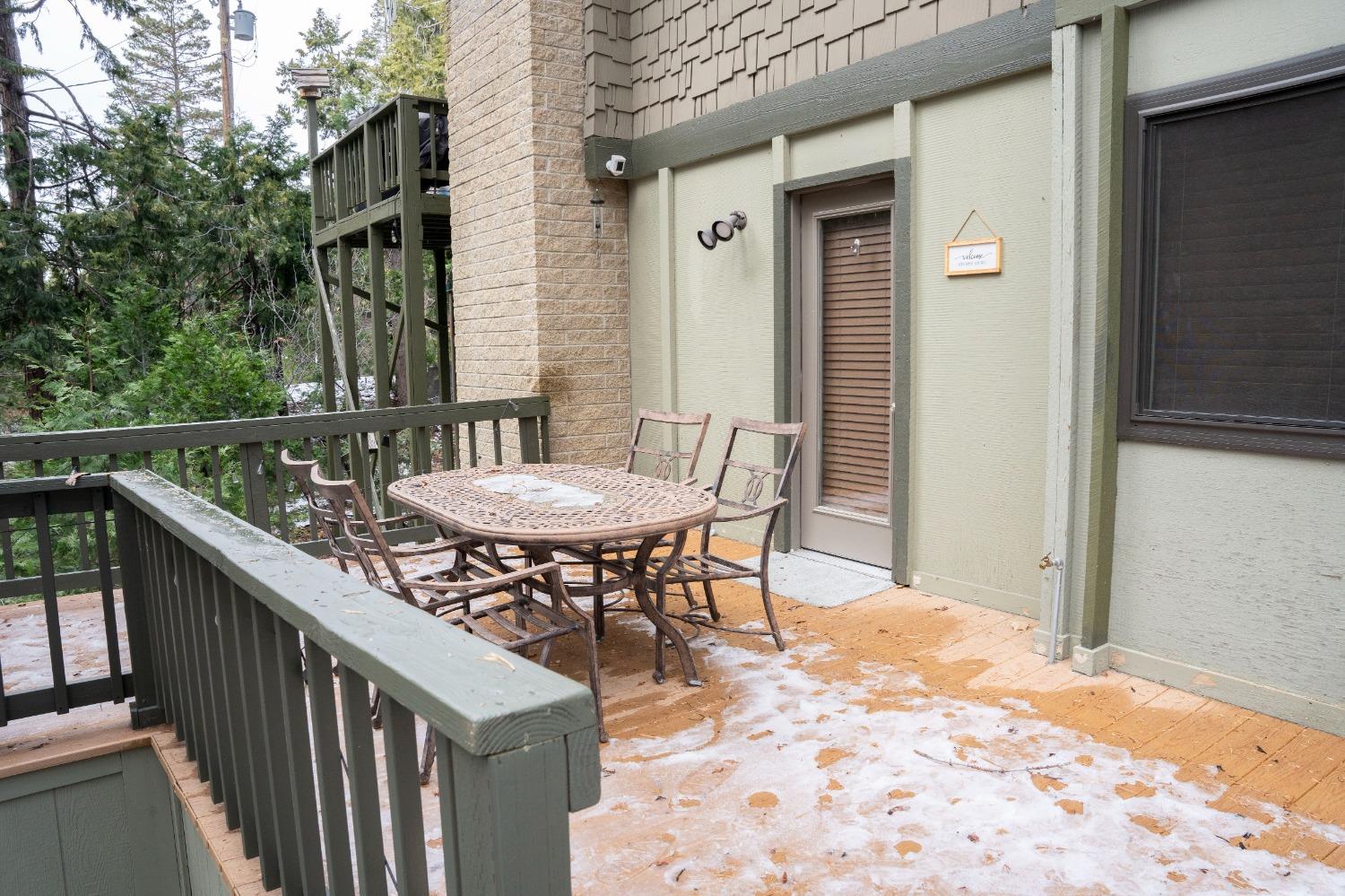 42135 Hanging Branch Road Shaver Lake, CA 93664 - Photo 13 of 55 a view of a patio with a table and chairs